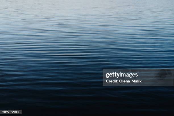 textured surface of blue water with reflections. perfect backdrop for your design. - vatten bildbanksfoton och bilder