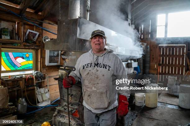 Maple syrup maker Carter Norris stands near the evaporator March 9, 2024 in Monkton, Vermont. Maple syrup is ready when it reaches 218F degrees....