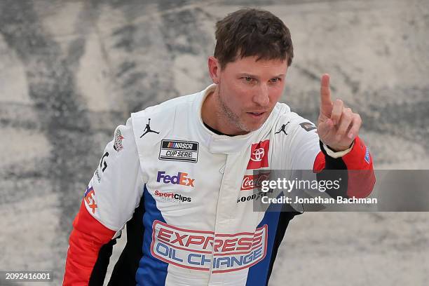 Denny Hamlin, driver of the Express Oil Change Toyota, celebrates after winning the NASCAR Cup Series Food City 500 at Bristol Motor Speedway on...