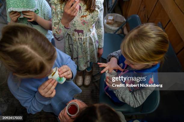 Local children taste freshly made maple syrup at Pat LeClaire's sugar house March 9, 2024 in Charlotte, Vermont. In 2023, LeClaire made 553 gallons...