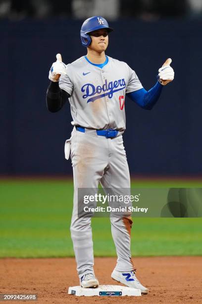 Shohei Ohtani of the Los Angeles Dodgers celebrates after stealing second base in the third inning during the 2024 Seoul Series game between the Los...
