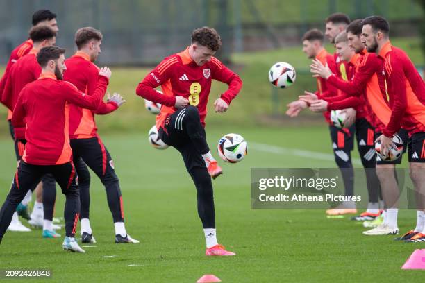 Nathan Broadhead kicks the ball during the Wales Football Training Session at The Vale Resort on March 20, 2024 in Hensol, Wales.