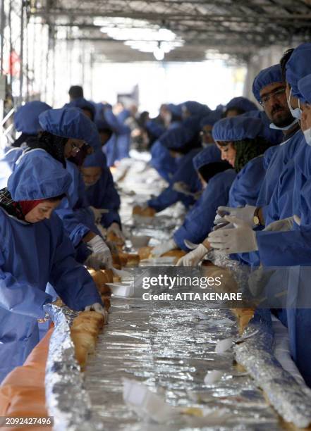 Iranians prepare a giant ostrich meat sandwich planned to reach 1,500 meters in an attempt to achieve a 'Guinness World Record', during the second...