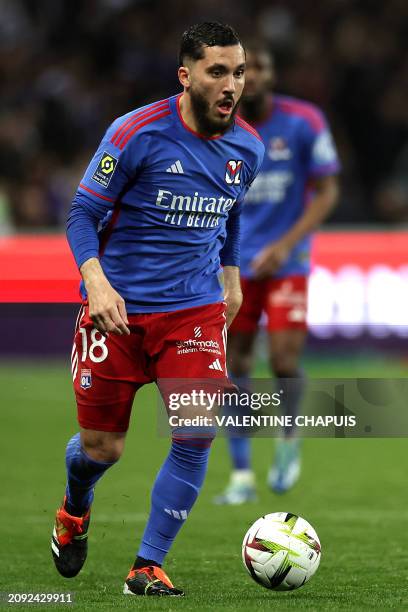 Lyon's French forward Rayan Cherki runs with the ball during the French L1 football match between Toulouse Football Club and Olympique Lyonnais at...