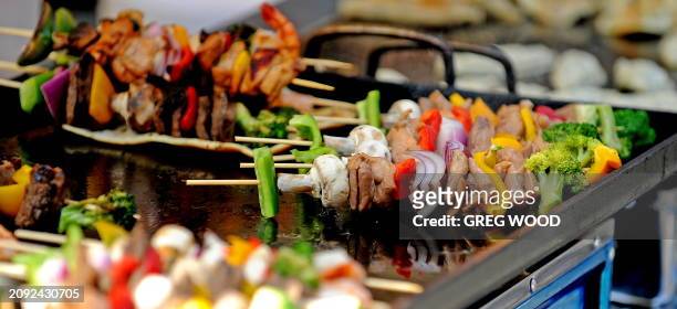 Meat and vegetables on skewers are barbecued at a Rocks Farmer's Market stall in Sydney's historic Rocks precinct on March 13, 2010. The Rocks is...