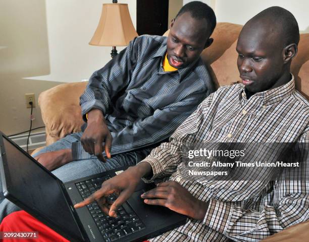 Chol-Awan Majok,left, and his brother, Aguto, of Sudan, follow the vote in South Sudan's secession referendum from a laptop at their Cohoes apartment...