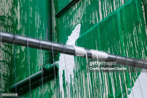 The recent 'Banksy' tree mural is fenced off after the artwork on the side of a building in north London was vandalised with white paint.