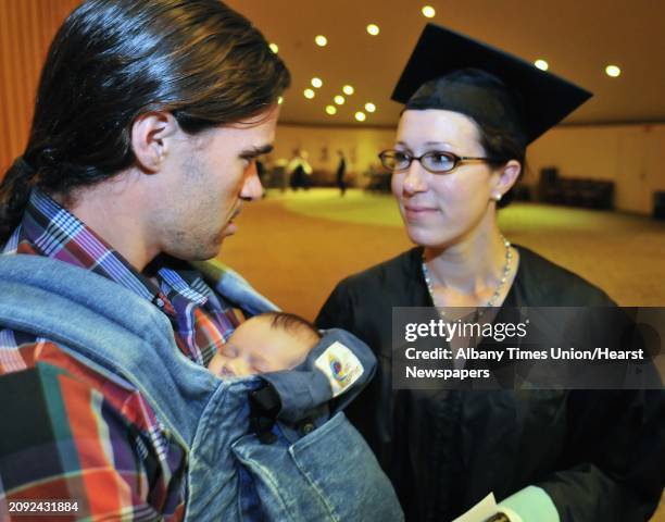 Master of Arts in Teaching graduate Brekke Holub, at right, of Oneonta gives some last minute instructions to Eamonn Hinchey for their daughter,...