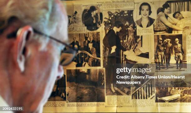 Author William Kennedy before a framed newspaper pictorial on the life of Legs Diamond at Kennedy's Albany townhouse Wednesday Sept. 14, 2011.