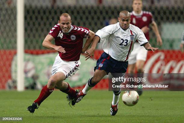 June 15: Claus Jensen of Denmark and Kieron Dyer of England challenge during the FIFA World Cup Finals 2002 Round Of 16 match between Denmark and...