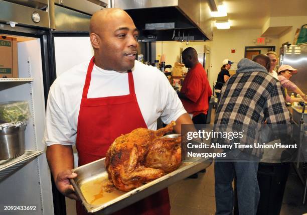 Executive chef Jacob Rowe of Bethesda House of Schenectady with one of the many turkeys they've prepared for hundreds of needy people being served an...