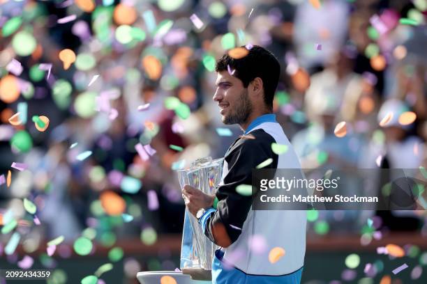 Carlos Alcaraz of Spain poses with the trophy after defeating Daniil Medvedev of Russia during the Men's Final of the BNP Paribas Open at Indian...