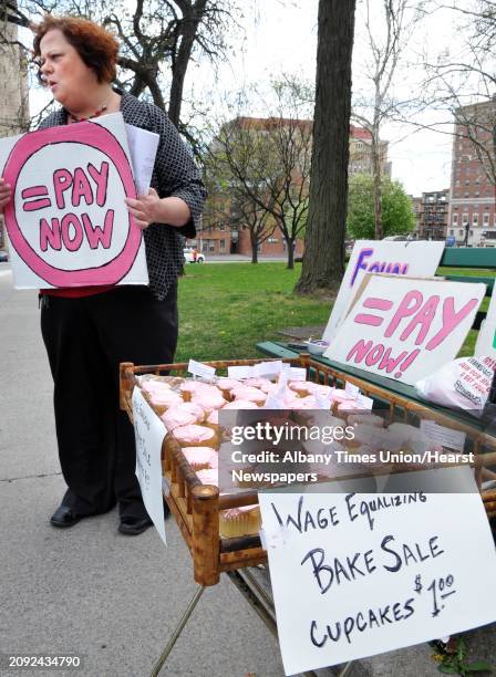 Laurel Young of Occupy Albany holds a "gender neutralizing" bake sale to protest pay inequity and gender discrimination on the east lawn of the...