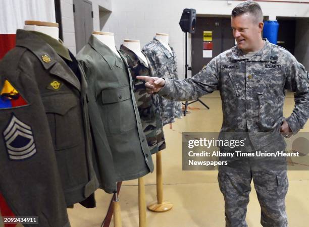 Maj. Drew Pinckney of North Greenbush discusses the evolution of US Army uniforms on display for a traditional ceremony commemorating June 14, 1775...