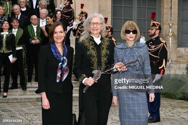 New member of the Academie des Beaux-Art US photographer Annie Leibovitz , holding her Academician Sword, poses with US ambassador to France Denise...