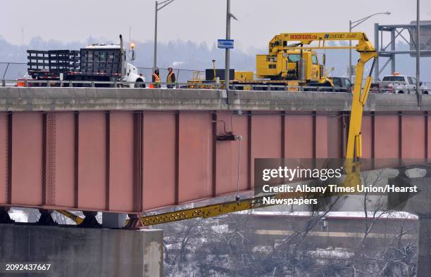 Workers have remove covers from the peregrine falcon nesting boxes on Dunn Memorial Bridge Tuesday Jan. 29 in Albany, N.Y. The screening was...