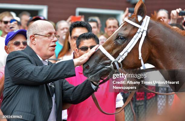 Schenectady native Ed Stanco pets his horse Princess of Sylmar after jockey Javier Castellano rode the horse to victory in the TVG Coaching Club...