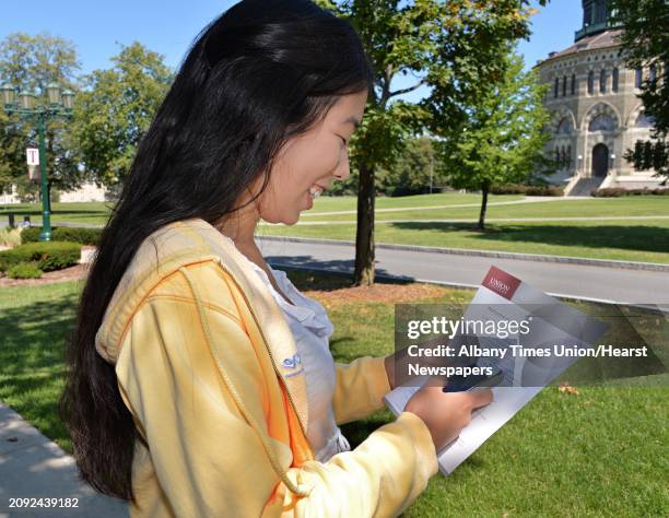 Kendra Blomstedt of Groton, Conn., stops to check a text during a summer open house for prospective students and their parents at Union College in...