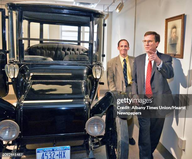 Union College President Stephen C. Ainlay, right, and engineering professor John Spinelli look over the 1914 Duplex Drive Brougham Detroit Electric...