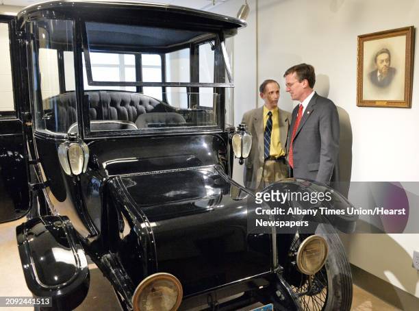 Union College President Stephen C. Ainlay, right, and engineering professor John Spinelli look over the 1914 Duplex Drive Brougham Detroit Electric...