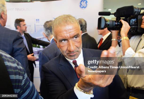 Albany Nanocollege CEO Alain Kaloyeros calls to an associate during the announcement of a new $500 million power electronics manufacturing consortium...