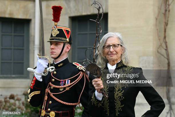 New member of the Academie des Beaux-Art US photographer Annie Leibovitz poses with her sword designed by Ariel Dearie after her induction ceremony...