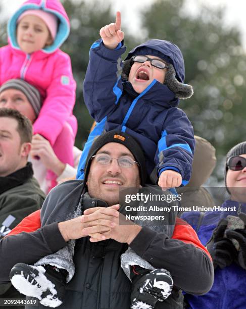 Held high on his father Matt Zichelli's shoulders, 5-year-old Nicholas Zichelli of Ballston catches sight of Santa Claus as he parachutes onto the...
