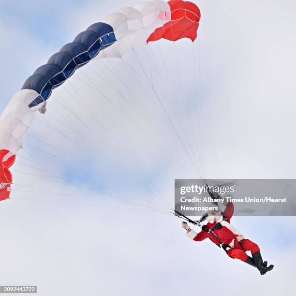 Santa Claus parachutes onto the EllmsÕ Christmas Tree Farm Saturday Nov. 29, 2014.