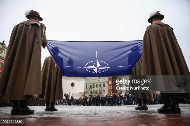 Soldiers of the Polish army hold NATO flag while taking part in official celebration of the 25th anniversary of Poland's accession to the structures...