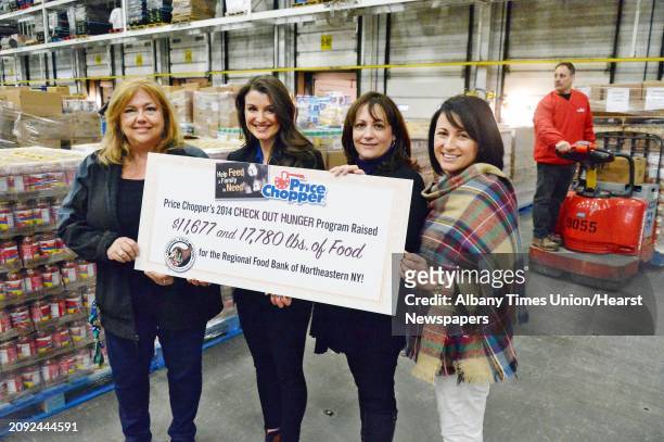Price Chopper's Pamela Cerrone, left, and Ashley Lonardelli present 1,300 CASES of food to the Regional Food Bank of Northeastern New York's Joanne...
