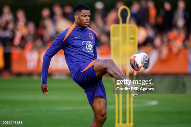 Denzel Dumfries of The Netherlands kicks the ball during the Training session of the Netherlands National Football Team at KNVB Campus on March 18,...