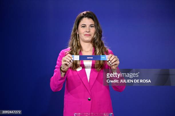 Canadian football player Stephanie Labbe holds up the paper slip of Japan as she proceeds to the draw for the Paris 2024 Olympic women football...