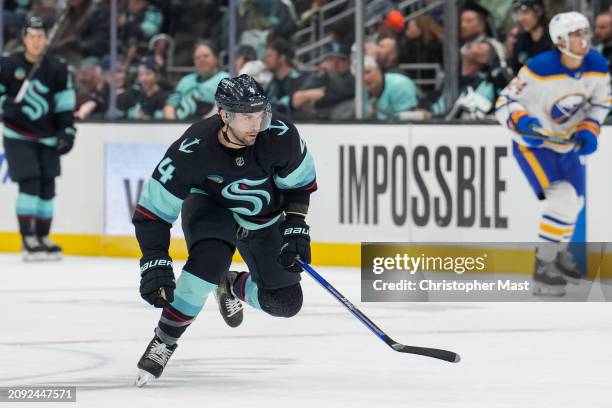 Justin Schultz of the Seattle Kraken skates back for the puck during the second period of a game against the Buffalo Sabres at Climate Pledge Arena...