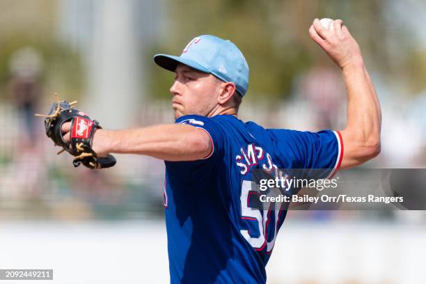 Adrian Sampson of the Texas Rangers pitches during a spring training game against the San Francisco Giants at Surprise Stadium on February 25, 2024...