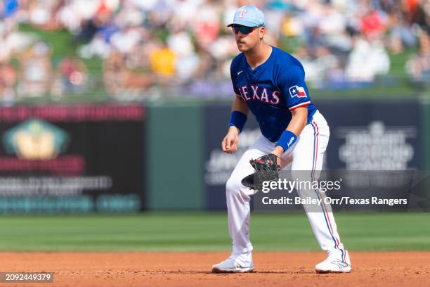 Nathaniel Lowe of the Texas Rangers gets set during a spring training game against the San Francisco Giants at Surprise Stadium on February 25, 2024...