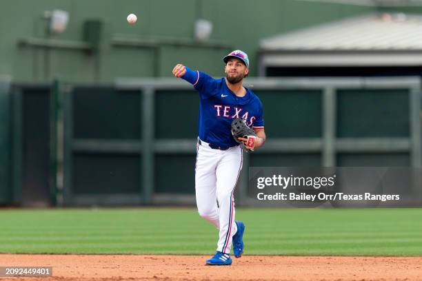 Jonathan Ornelas of the Texas Rangers fields the ball during a spring training game against the San Francisco Giants at Surprise Stadium on February...