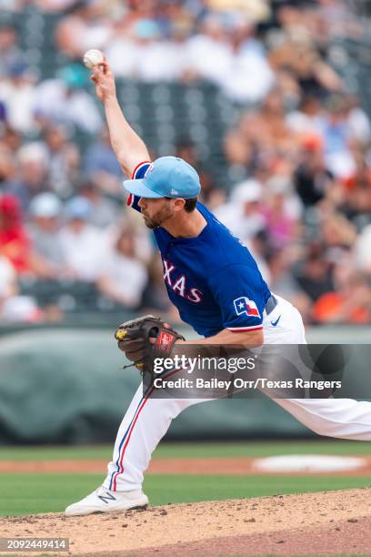 Justin Pruitt of the Texas Rangers pitches during a spring training game against the San Francisco Giants at Surprise Stadium on February 25, 2024 in...