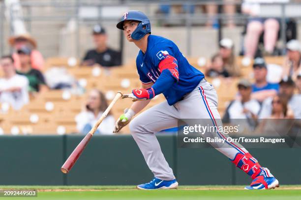 Justin Foscue of the Texas Rangers bats during a spring training game against the Chicago White Sox at Camelback Ranch on February 26, 2024 in...