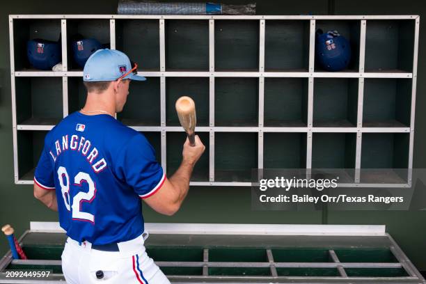 Wyatt Langford of the Texas Rangers in the dugout prior to a spring training game against the San Francisco Giants at Surprise Stadium on February...