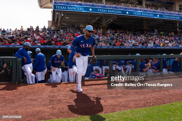 Marcus Semien of the Texas Rangers takes the field prior to a spring training game against the San Francisco Giants at Surprise Stadium on February...