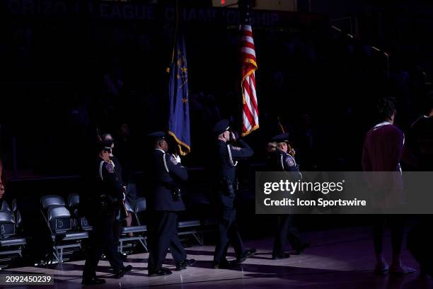 The Indianapolis Police Honor Guard March the Colors out for the National Anthem prior to the start of the mens Horizon League Championship game...