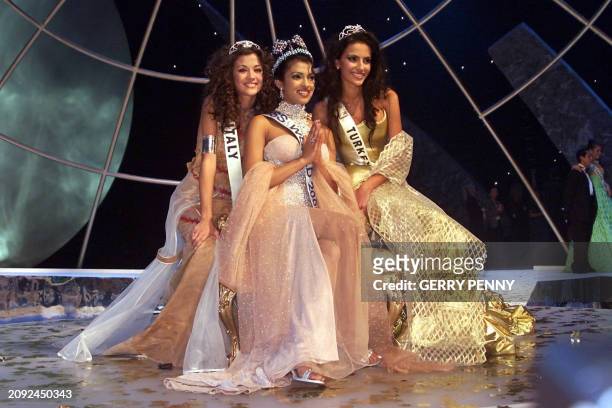 Year-old Priyanka Chopra of India poses after winning the Miss World final with second placed 18-year-old Giorgia Palmas of Italy and third placed...