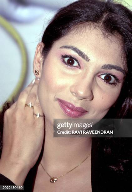 Former miss world 1999 Yukta Mookhey poses with diamond earrings, necklace and rings during the launch of Oyzterbay's "Your First Diamond" collection...