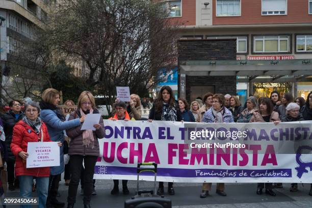 Woman is reading a manifesto in front of the banner ''against sexist terror, feminist struggle'' during the rally at the town hall square in support...