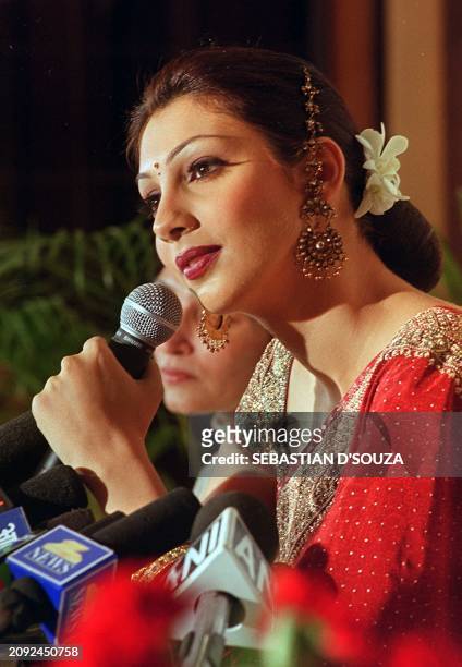 Miss World Yukta Mookhey dresses in a red Indian saree, meeting the press 16 December 1999 in Bombay. Mookhey said that she would work to raise funds...