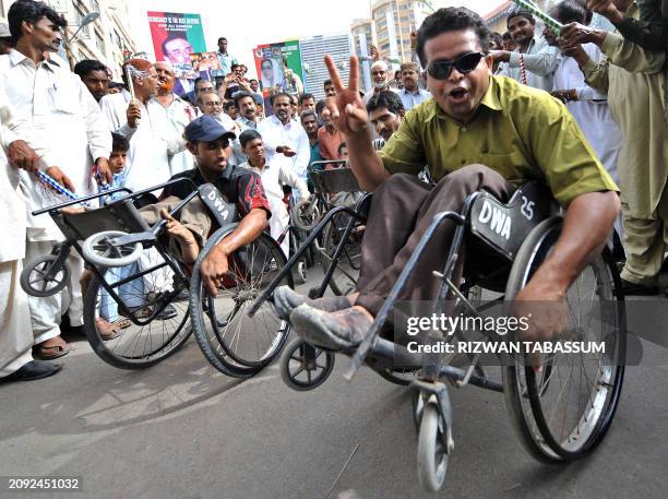 Disabled persons and supporters of the ruling Pakistan People's Party dance to celebrate the swearing-in of the party's co-chairman Asif Ali Zardari...