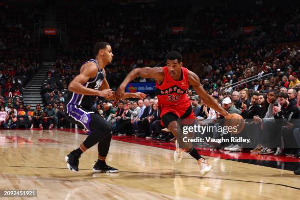 Ochai Agbaji of the Toronto Raptors dribbles the ball during the game against the Sacramento Kings on March 20, 2024 at the Scotiabank Arena in...