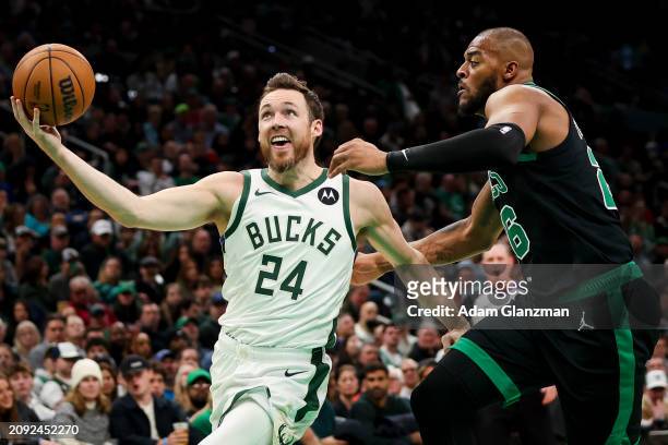 Pat Connaughton of the Milwaukee Bucks drives to the basket against Xavier Tillman of the Boston Celtics at TD Garden on March 20, 2024 in Boston,...