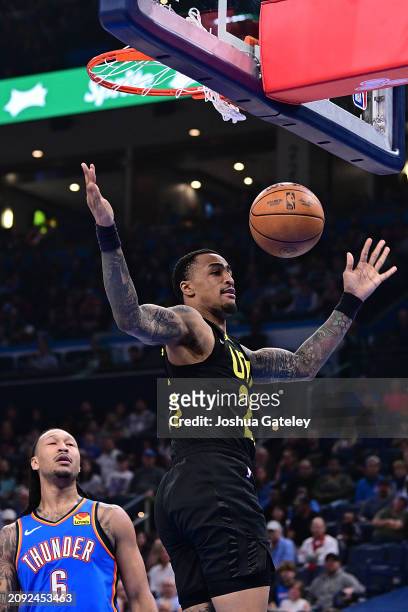 John Collins of the Utah Jazz finishes a slam dunk against Oklahoma City Thunder during the first half at Paycom Center on March 20, 2024 in Oklahoma...