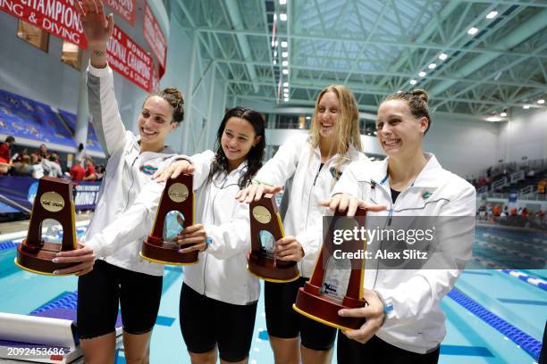 Emma Weyant, Bella Simms, Micayla Cronk and Isabel Ivey, of the Florida Gators pose with the trophy after winning the Women's 800 Yard Freestyle...